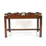 A mahogany butler's tray and stand of traditional design,