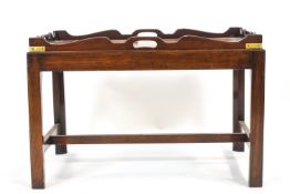 A mahogany butler's tray and stand of traditional design,