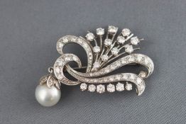 A white metal diamond spray brooch.