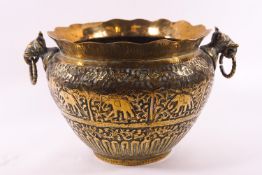 A 19th century Indian brass planter repousse decorated with elephants and two elephant head handles,
