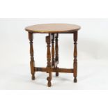 A small oak round folding table raised on a bobbin turned gate leg mechanics. 52cm high x 50cm wide.