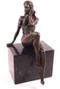 J Patoue, lady seated on a black marble plinth,