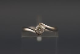 A white metal single stone ring set with a round brilliant cut diamond of approximately 0.32 carats.