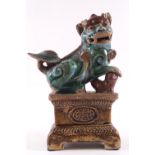 A Chinese earthenware figure of a Buddhist Temple Lion,