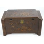 A Camphor wood chest of traditional form and carved with Asian scenes, set an inner tray,
