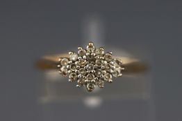 A yellow metal cluster ring set with twenty three single cut diamonds.