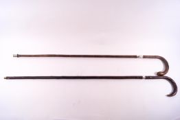 Two ladies walking sticks, one with hallmarked silver collar, the other unmarked,