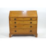 A George III mahogany bureau with fall front (key in reception) over a pair of lopers,