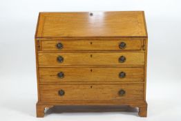 A George III mahogany bureau with fall front (key in reception) over a pair of lopers,