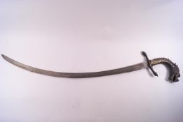 An Indian sword with a long, curved steel blade and set with a bronzed, cast dragons head handle,