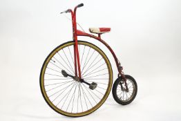 A 'Ron Cooper' child's penny farthing, the frame in red,