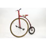 A 'Ron Cooper' child's penny farthing, the frame in red,