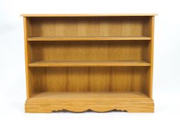 A 20th century standing oak bookcase with three fixed shelves, 95cm high, 127cm wide,