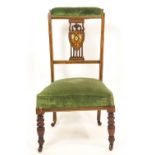An Edwardian mahogany prie dieu chair with heart shaped splat inlaid with putti