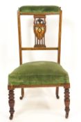 An Edwardian mahogany prie dieu chair with heart shaped splat inlaid with putti