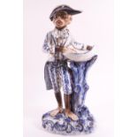 A Continental hard past porcelain sweetmeat dish in the form of a monkey in a bicorn hat,