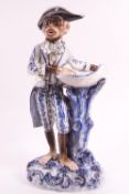 A Continental hard past porcelain sweetmeat dish in the form of a monkey in a bicorn hat,