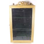 A gilded wall display cabinet of rectangular form set with a plain glazed door
