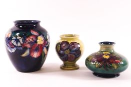 Three Moorcoft vases, the largest decorated with iris on a blue green ground,