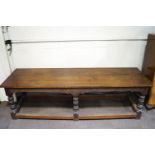 A large oak refectory table with four plank top on six turned legs linked by stretchers 82cm high,