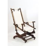 An early 20th century American style turned dark wood rocking chair
