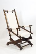 An early 20th century American style turned dark wood rocking chair