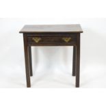 An elm wood late Georgian side table with rectangular top over a frieze drawer