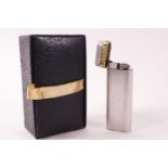 A Cartier brushed metal and gold finish gas lighter