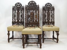 A set of four carved oak dining chairs in the style of Daniel Marot,