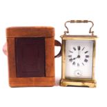 A brass carriage clock alarm clock, of traditional form, in original travelling case,