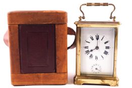 A brass carriage clock alarm clock, of traditional form, in original travelling case,