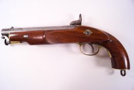 A reproduction percussion cap single barrel pistol, the hardwood stock with a brass set stock end,