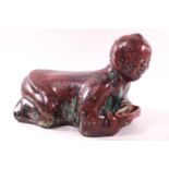 A flambe and turquoise glazed terracotta Chinese head sleeping block in the form of a crouching man