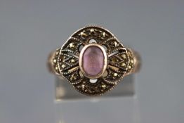 A white metal ring set with a pale amethyst and finished with marcasites.