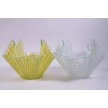 Two glass handkerchief bowls, decorated in a gingham pattern, one in yellow, one in white,