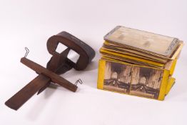 A 19th century wooden adjustable slide stereoscope with a selection of images,