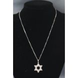 A white metal star pendant set with diamonds of approximate total weight 1.00cts.