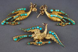 A yellow metal demi parure of brooch and earrings, designed as peacocks...
