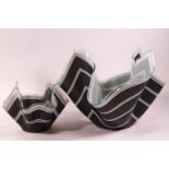 Two glass handkerchief bowls, decorated with white stripes on a black ground,