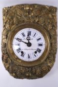 A French pressed brass Pendule D'Alcove clock decorated with fruiting vines and wheat sheafs