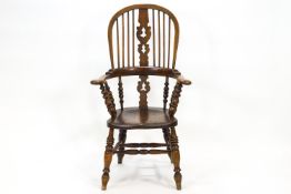 An elm and bentwood stick back chair with pierced splat over shaped arms on bobbin turned spindles,