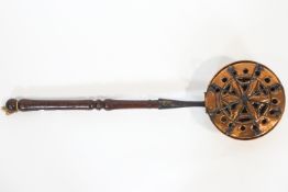 A late 17th century brass and wrought iron bed pan fumigator with turned handle,