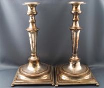 A pair of silvered copper candlesticks with bead edge decoration to the baluster trumpet stems,