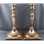 A pair of silvered copper candlesticks with bead edge decoration to the baluster trumpet stems,