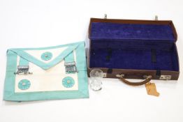 A cased Masonic apron and a Masonic firing glass,