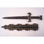 A decorative cast metal Chinese style dagger and scabbard with bronze patina,