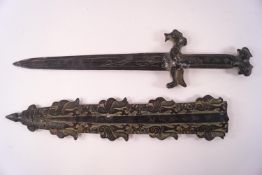 A decorative cast metal Chinese style dagger and scabbard with bronze patina,