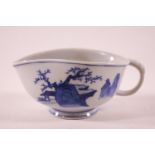 A Chinese porcelain sauce boat, painted in under glaze with figures in a landscape,