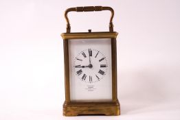 A brass cased repeater carriage clock with white enamel Roman chapter dial marked 'examined by Dent,