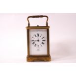 A brass cased repeater carriage clock with white enamel Roman chapter dial marked 'examined by Dent,